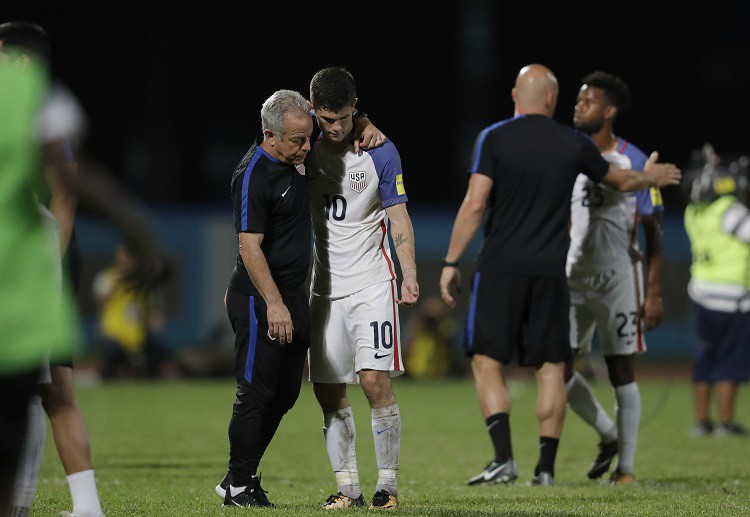 Bruce Arena and Christian Pulisic walk together after USA's shocking disqualification at the FIFA World Cup 2018