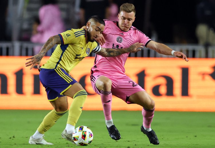 Cristian Arango tries to dribble past Julian Gressel during their Major League Soccer match